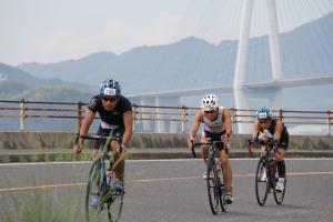 多々羅大橋をバックに自転車で走る選手の画像
